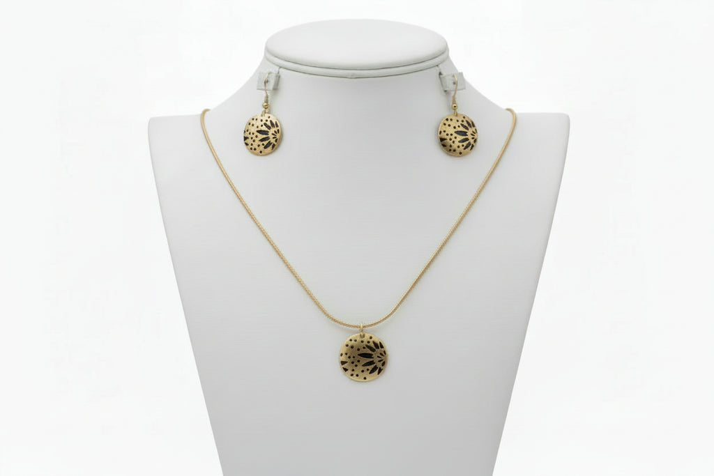 Gold necklace and earrings on a white mannequin bust