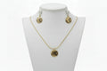Gold necklace and earrings on a white mannequin bust