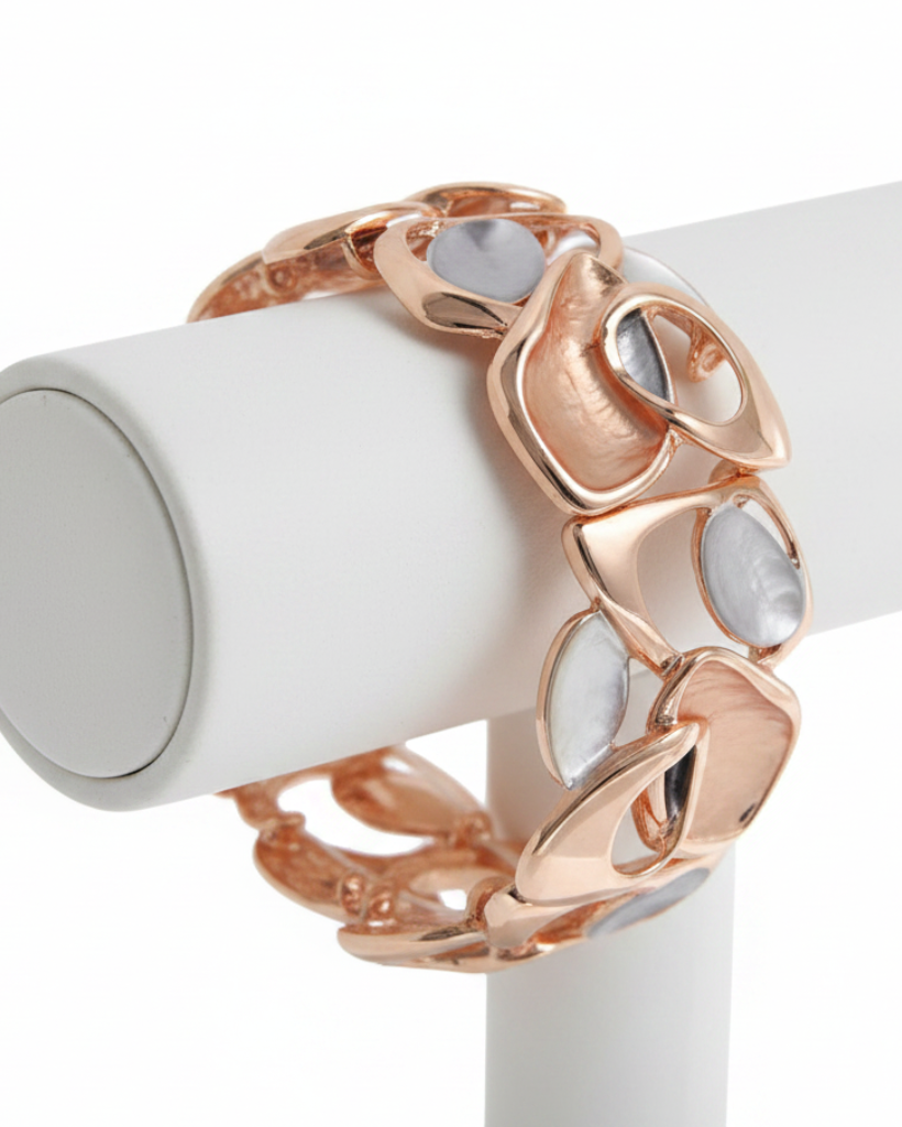 Rose gold bracelet with white stones on a white stand