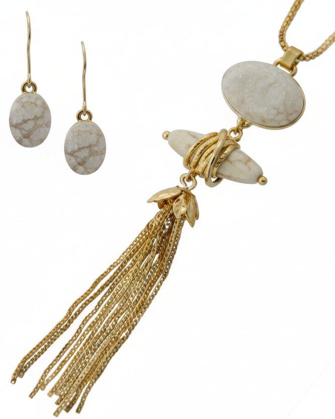 Necklace with tassel and shell earrings on a white background