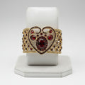 Gold bracelet with red gemstones on a white background