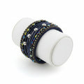 Navy blue bracelet with multicolored beads on a white background