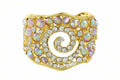 Gold spiral bracelet with pink and white stones on a white background