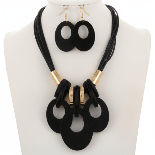 Black necklace and earrings set on a white background