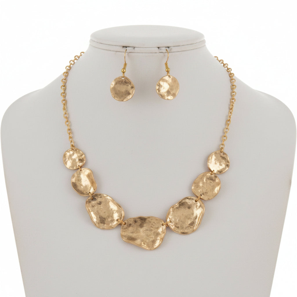 Gold necklace and earrings on a white background