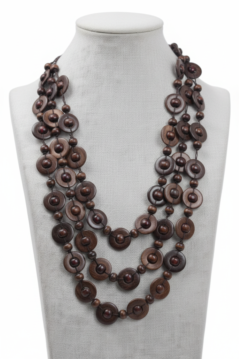 A multi-strand statement necklace made of dark brown wooden beads with white painted accents, displayed on a white mannequin bust against a white background.