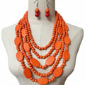 Neon orange beaded necklace and earrings on a mannequin bust.