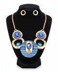 Jewelry set with blue stone necklace and earrings on a white background