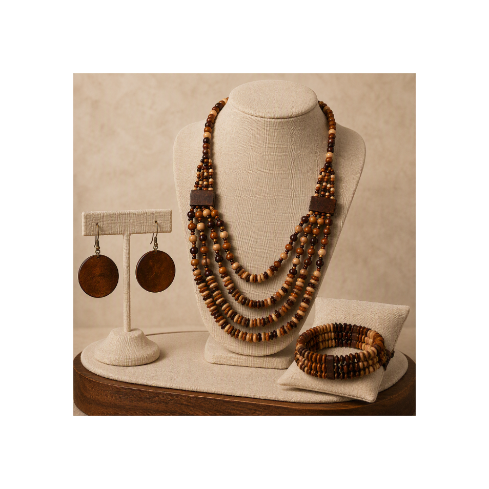 A multi-strand wooden bead necklace displayed on a beige jewelry bust, with matching wooden disc earrings on a separate stand and a matching wooden beaded bracelet on a cushion, all set against a warm beige background.