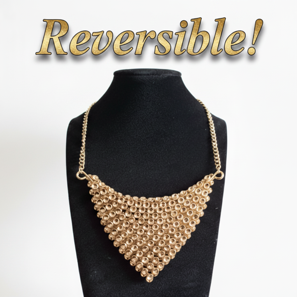 Gold necklace on a black mannequin bust