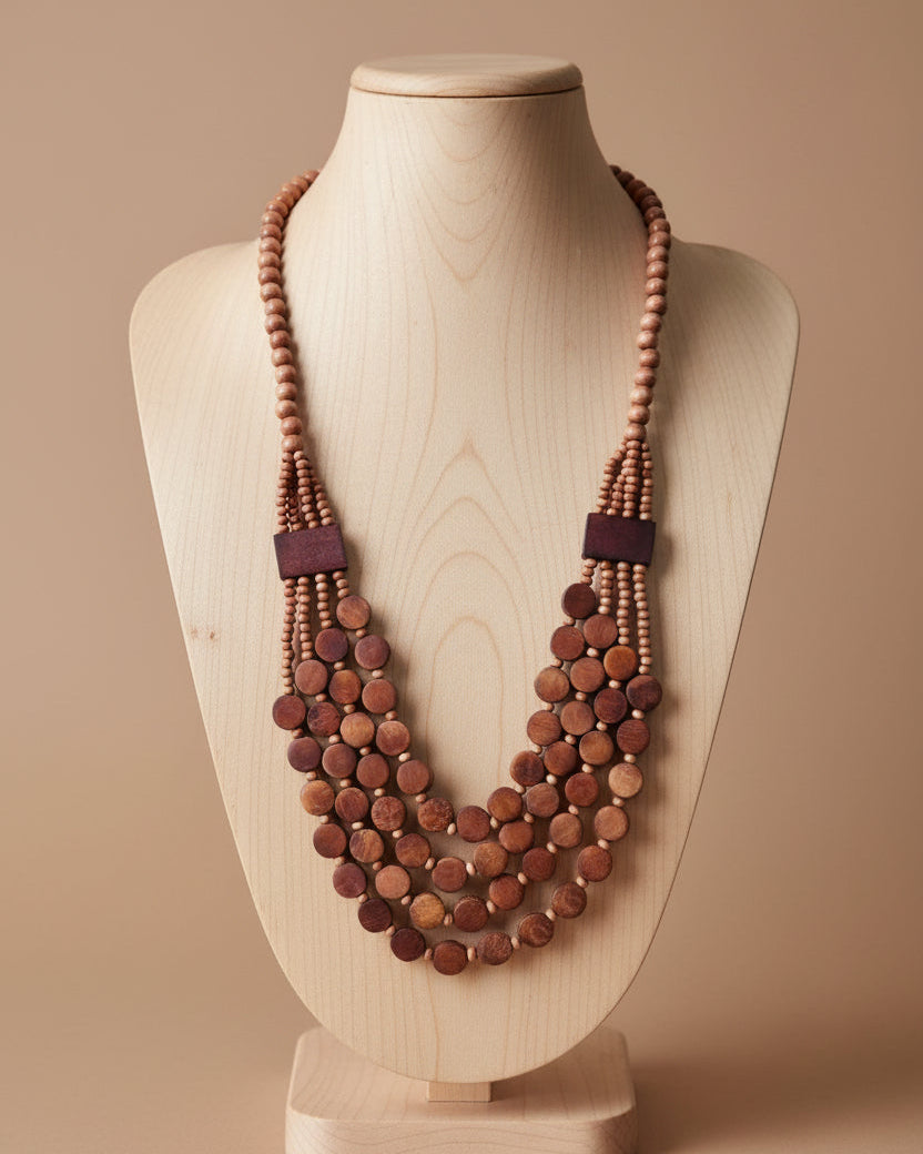 Multistrand wooden beaded necklace on a beige background