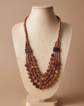 Multistrand wooden beaded necklace on a beige background