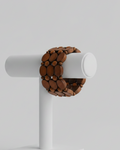 Brown wooden cube on a gray background