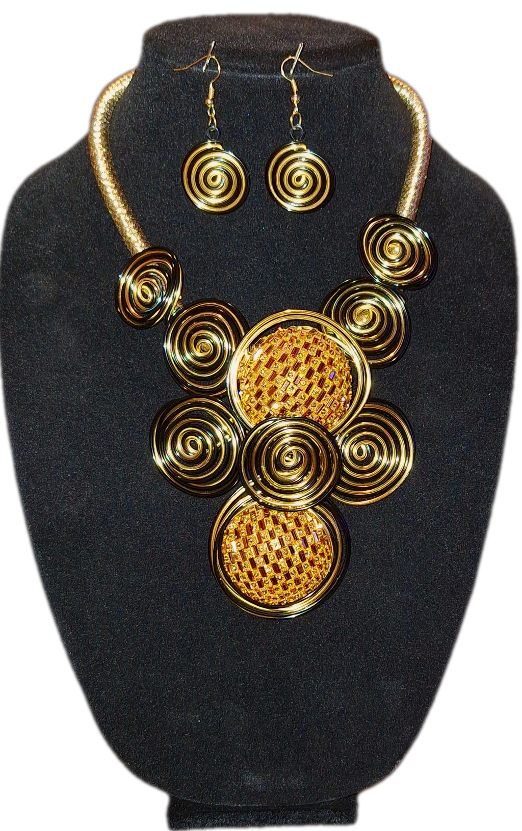 Gold circular necklace and earrings set on a black stand