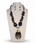 Jewelry set with necklace and earrings on a mannequin bust.