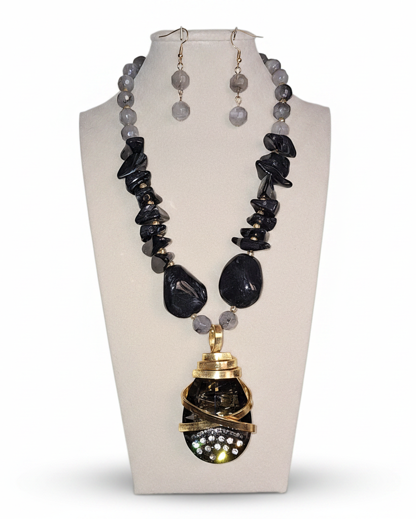 Jewelry set with necklace and earrings on a mannequin bust.